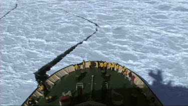 High angle looking down on prow of Russian ice-breaker sailing and breaking the ice in the Weddell Sea, Antarctica. The ice cracks and drifts apart.