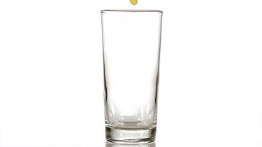 Orange Juice being poured into Glass against White Background, Slow Motion