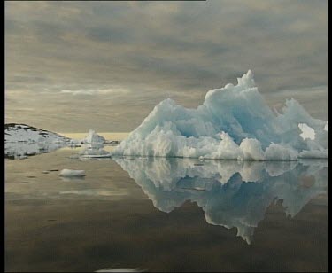 Track around iceberg, reflected in still water