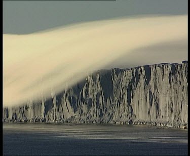 Thick layer of very low cloud over coastal cliffs, like a tablecloth.