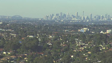 Wide Shot. Sydney city and suburbs. Harbour Bridge on LHS.