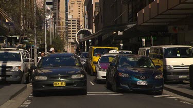 Traffic, cars driving through central Sydney street.