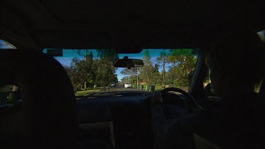 Point of View POV driving in a car, highway (over shoulder of woman driving).