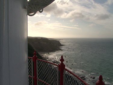 View of ocean and cliffs below from lighthouse