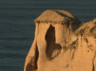 Warm orange light on eroded limestone rock feature.