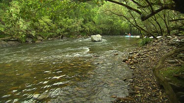 Kayaking down rapids.