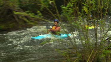 Kayaking down rapids.