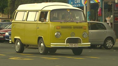 Volkswagen Kombi Vans driving through Byron Bay.