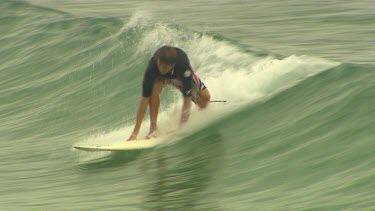 Surfer rides wave falls, wipeout.