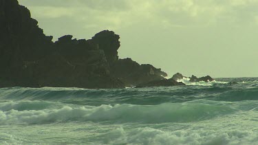Crashing waves on rocks, beach