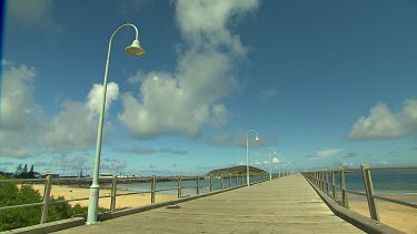 Long shot down jetty Coffs harbour, waterfront.