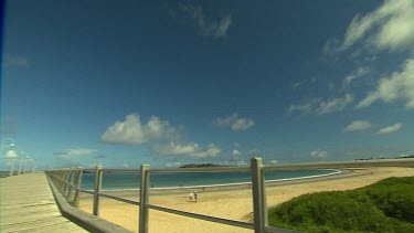 Long shot down jetty Coffs harbour, waterfront.