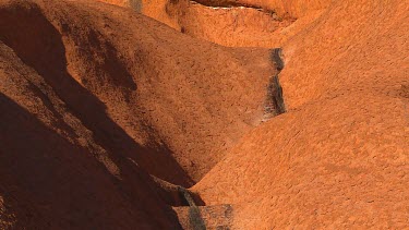 Rocks Uluru showing eroded channel where water flows when it rains.