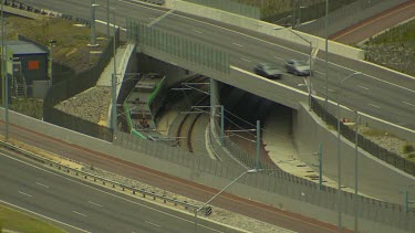 Transport. Cars drive over bridge over railway, train below.