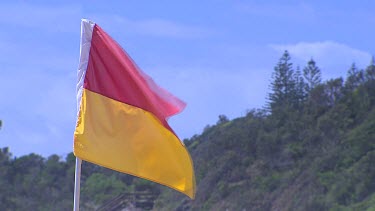 Surf lifesaving flag, red and yellow stripes.