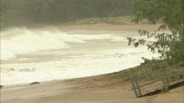 Storm. Rough seas. Waves crash onto beach.