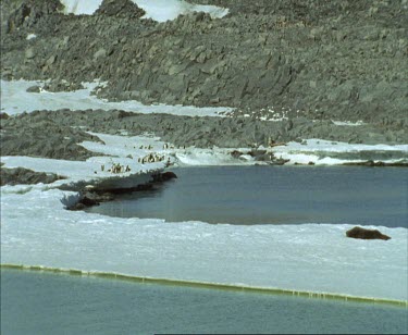 Frozen ice over Commonwealth Bay, Antarctica. Pan to Mawson's huts