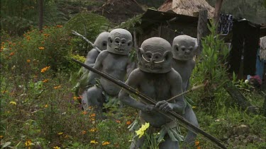 "Sorrow Dance" dance for honey bees. Men in traditional Papua New Guinean tribal dance wear. Men cover themselves in white chalk or ash.