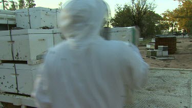 Beekeepers and hives. Loading hives onto truck.