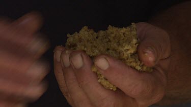 Man's hands moulding bee's wax.