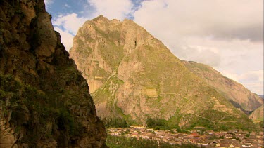 Panning shot of Ollantaytambo in the Sacred Valley or the Urubamba Valley  in Peru with the Inca storehouses in the background