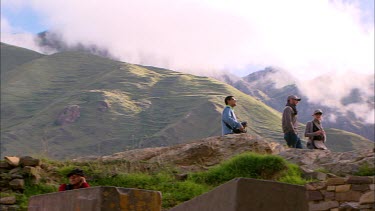 Tourist standing on the rock terraces in Ollantaytambo