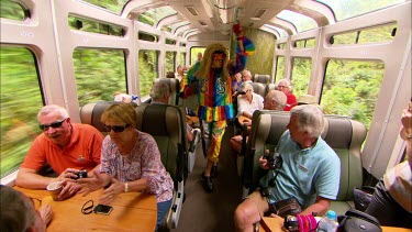 A man wearing and dancing in a traditional Incan costume of Diablo on a Vista Dome train