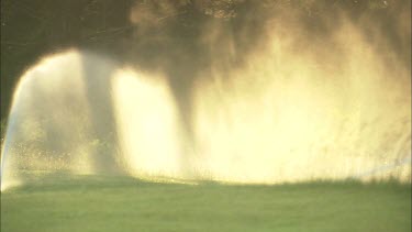 Water sprinklers in sunlight.