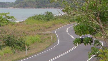 Car driving on rural road.