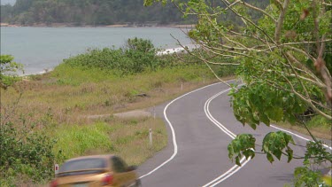 Car driving on rural road.