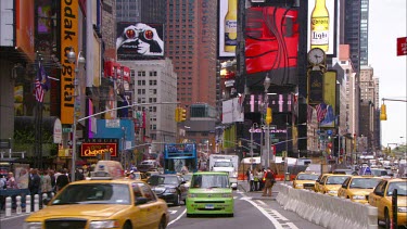 Times Square. Advertising LCD billboards. Broadway. Yellow New York cabs and traffic.