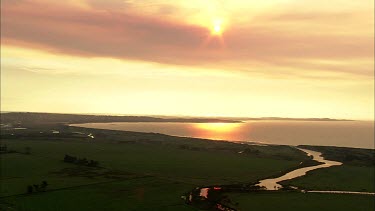 Sunset coast and meandering river. River Delta. Gordon River or Strahan?