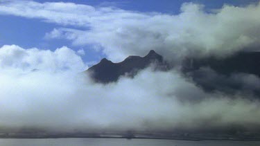 WS. Mist and low clouds blowing over sea and across mountains