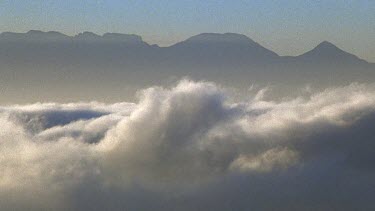 Mist blows across screen. Mountain in BG.