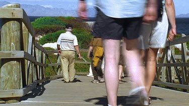 People going down to the beach along a boardwalk