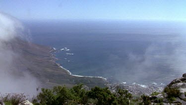 View of Cape Town from Table Mountain becomes totally obscured by thick mist as cloud passes over top of mountain.