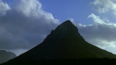 Clouds gather over apex of mountain Lion's Head Cape Town