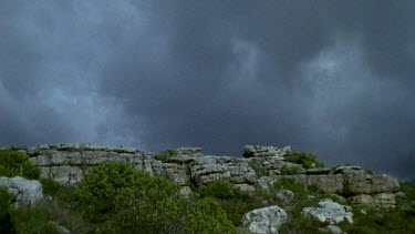 Rain clouds and strong winds blow over mountain