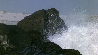 Big wave hits rock