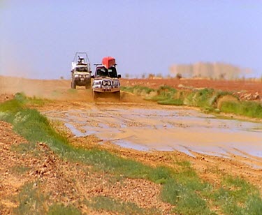 Slo-mo shot of 4wd four wheel drive. Mud splashing driving.