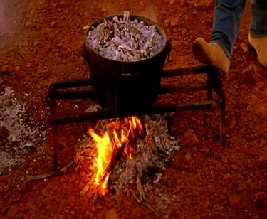 Cowboys with campfire at sunset. Silhouette. Billycan