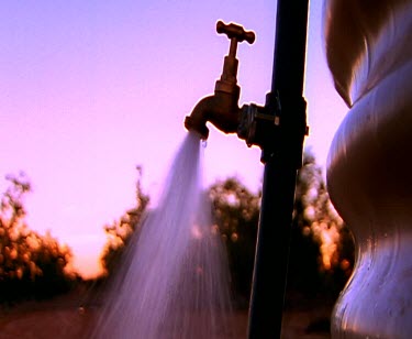 Tap water sprinkling irrigation watering the grass water flowing