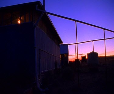 Sunset with very orange sky. Shearers gather at night