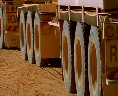 ECU wheels of road train petrol tanker truck. Filling up with petrol. In the Outback all produce is moved by truck. These huge rigs are called road trains. This petrol tanker is more than 53 metres lo...