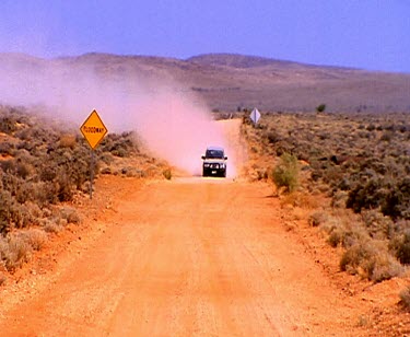 4 WD Four wheel-drive in outback, red earth. High angle mob of kangaroo