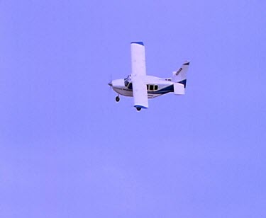 Light airplane fling against blue sky.