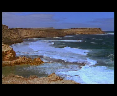 Cliffs and bay. Wave gently rolling