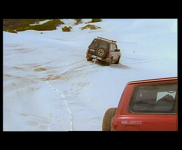 4wd towing four-wheel drive out of sand. Stuck in sand dune.