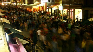 The frenzied pace of a massive street party is captured as thou South Australia; SAnds converge o  shop fronted road.