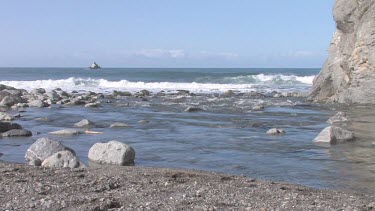 Gentle waves on pristine cove and shoreline